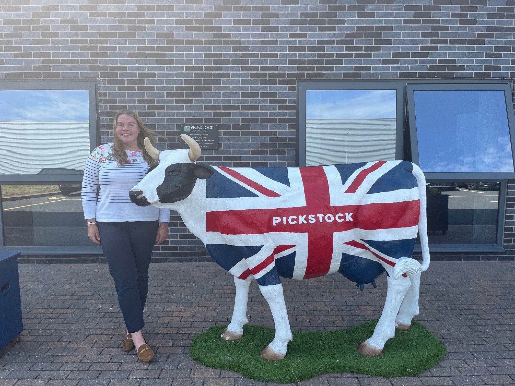 Efa with a cow statue decorated in the British flag with 'Pickstock' written on it - one of the Next Generation of Beef Industry Leaders